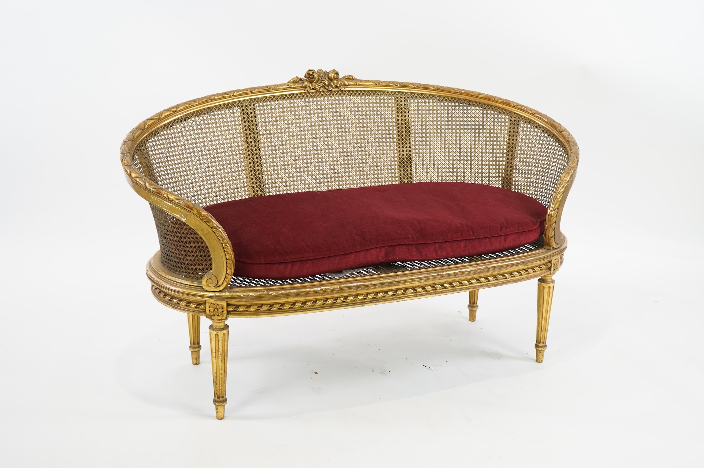 A late 19th / early 20th century French caned giltwood and composition canapé